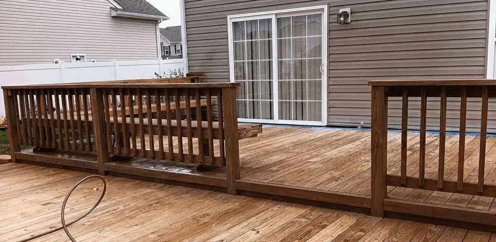 Deck sealing service protecting a backyard wood deck and railings in West Palm Beach, FL