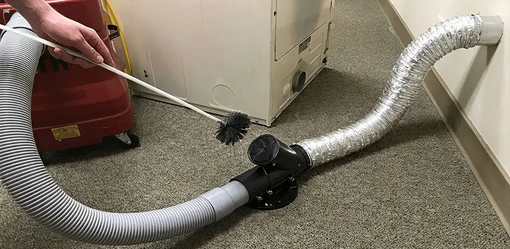 Dryer vent cleaning service removing lint from a dryer duct connection in West Palm Beach, FL