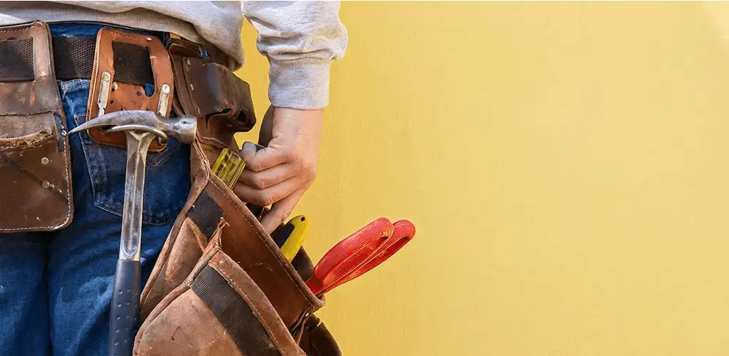 Handyman with tool belt ready for home repairs and maintenance in West Palm Beach, FL