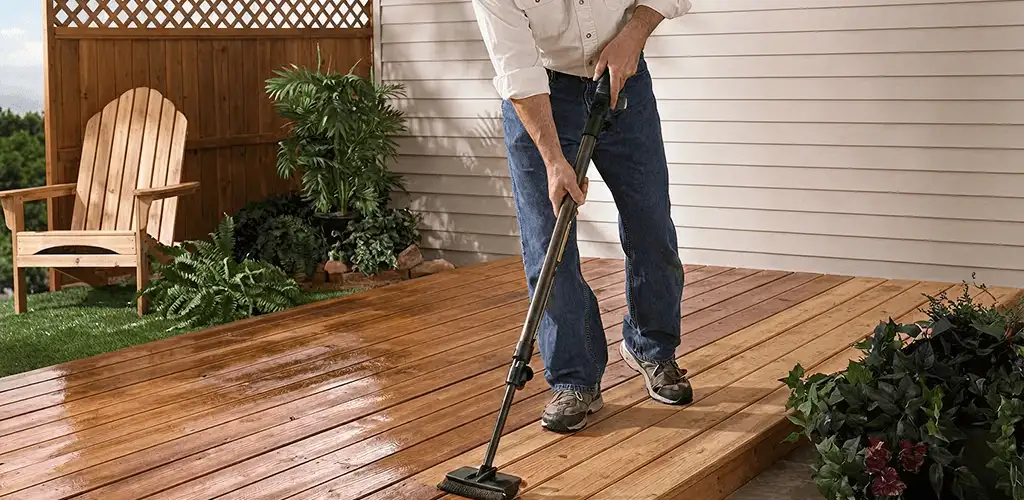Deck staining service applying stain to a backyard wood deck in West Palm Beach, FL